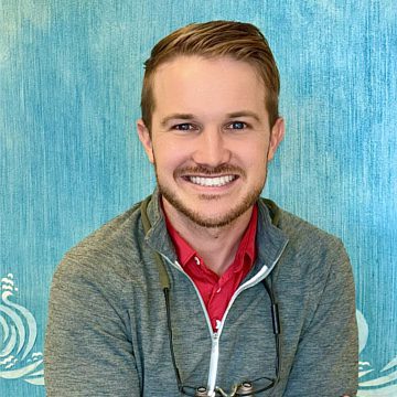 Pediatric dentist in Arnold, MO smiling in a professional office setting